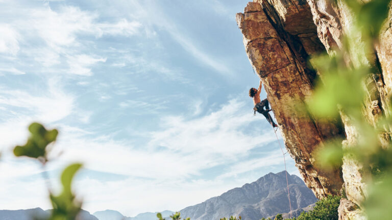 A climber climbs a mountain.