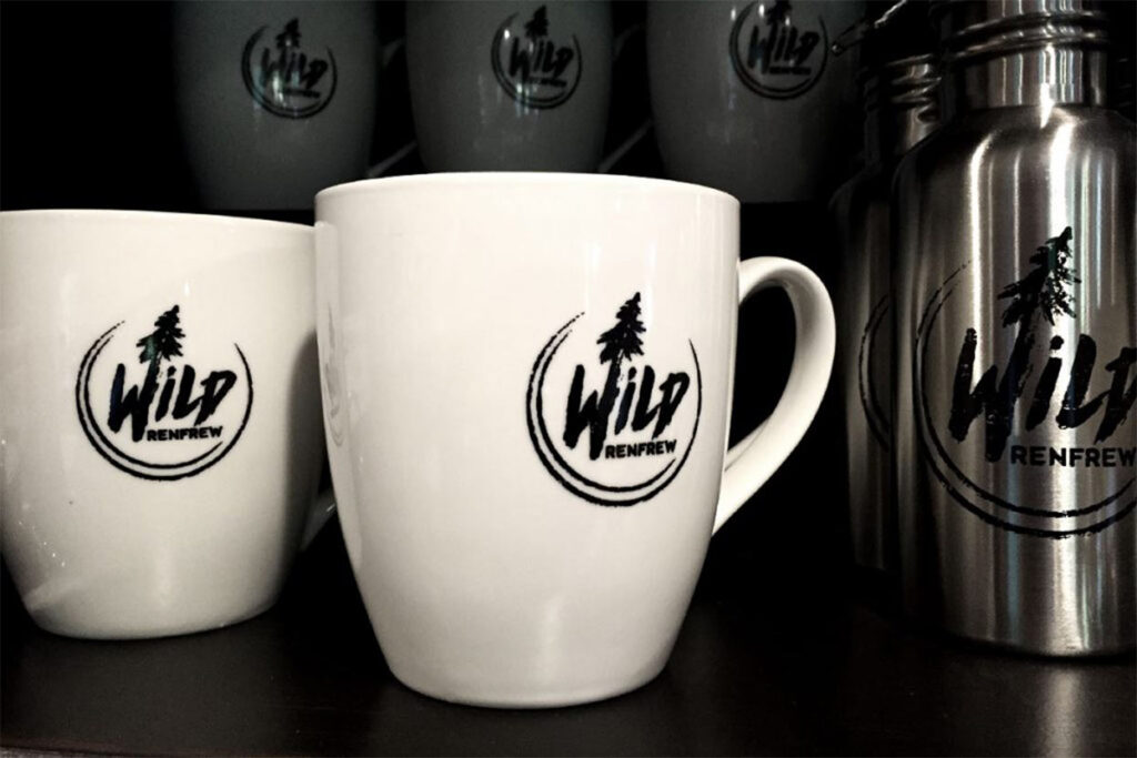 Mugs and thermoses branded with Wild Renfrew logos. 