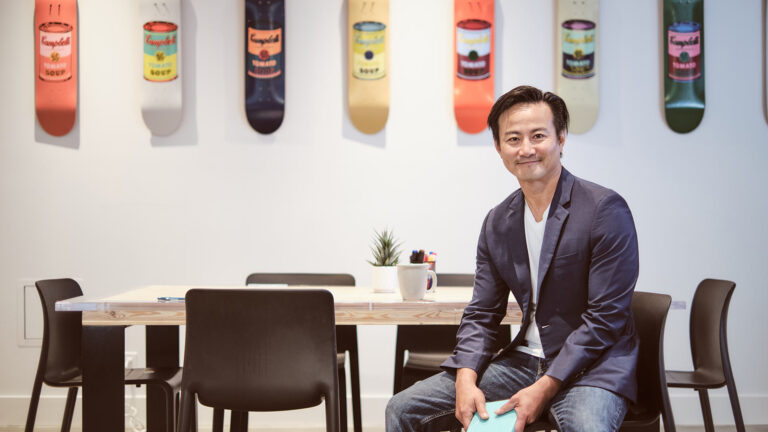 Neil Tran sits in the Leap studio board room, reflecting on the Leap anniversary.