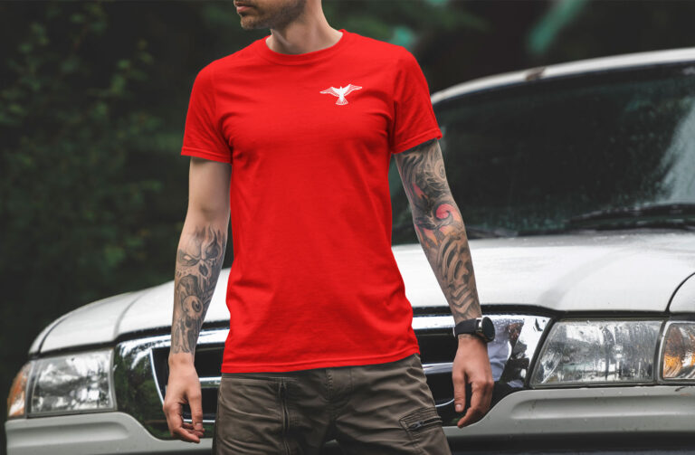 A man wears a t-shirt with the Strong Construction logo